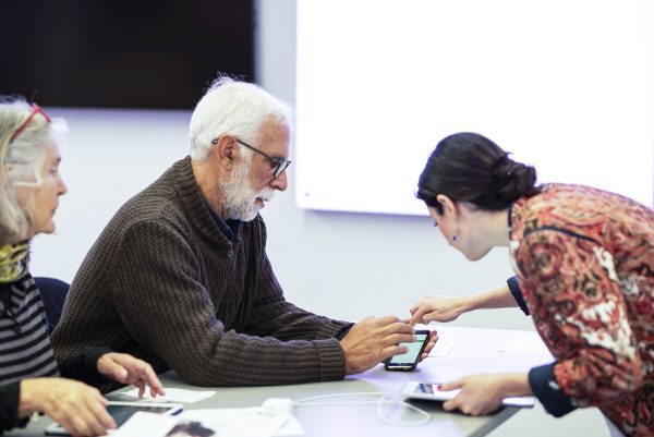 a staff member helping patrons with their devices