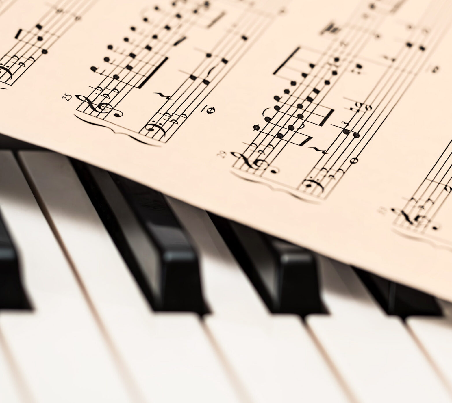 sheet music against piano keys