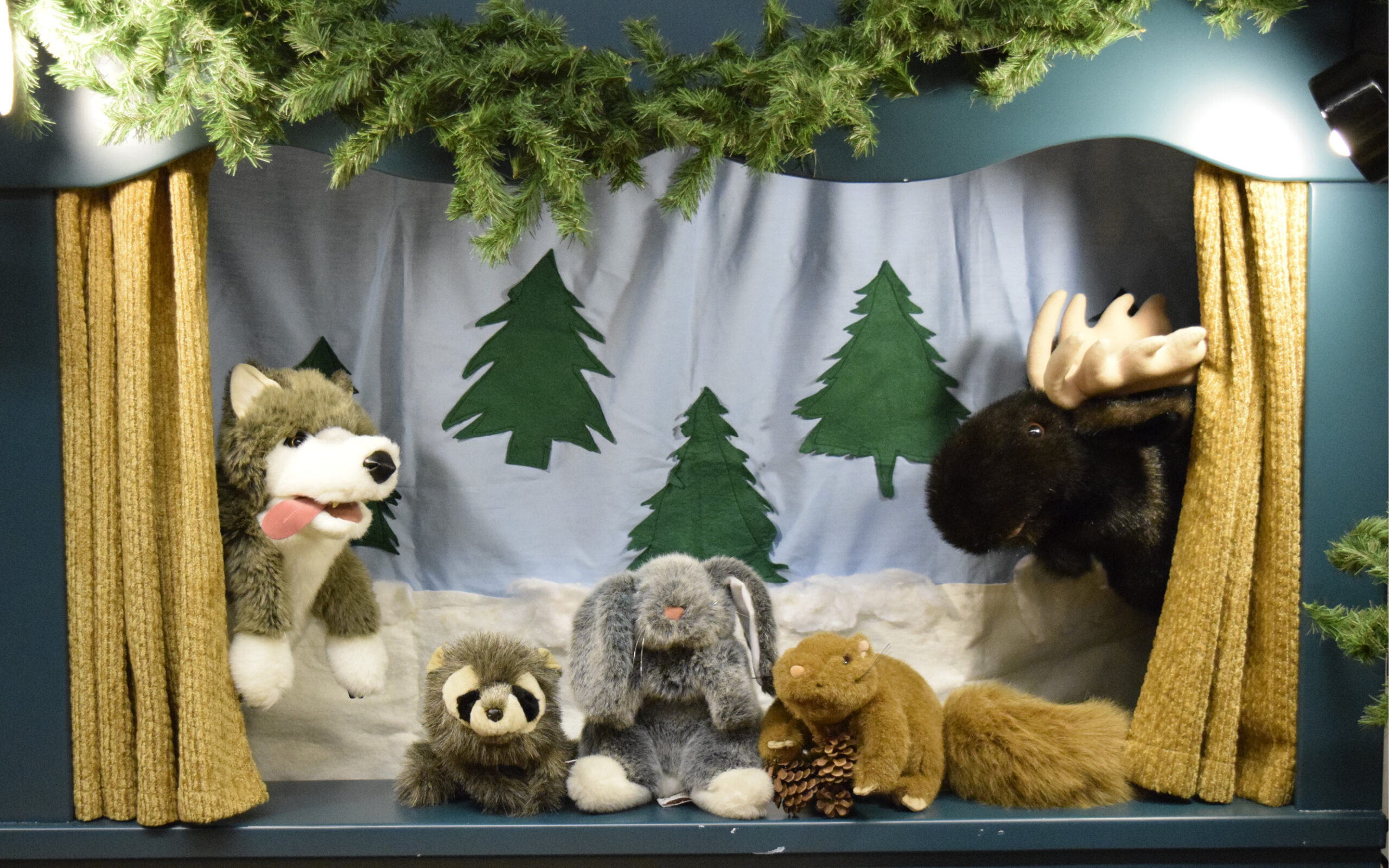 Woodland animal puppets in front of a snowy backdrop
