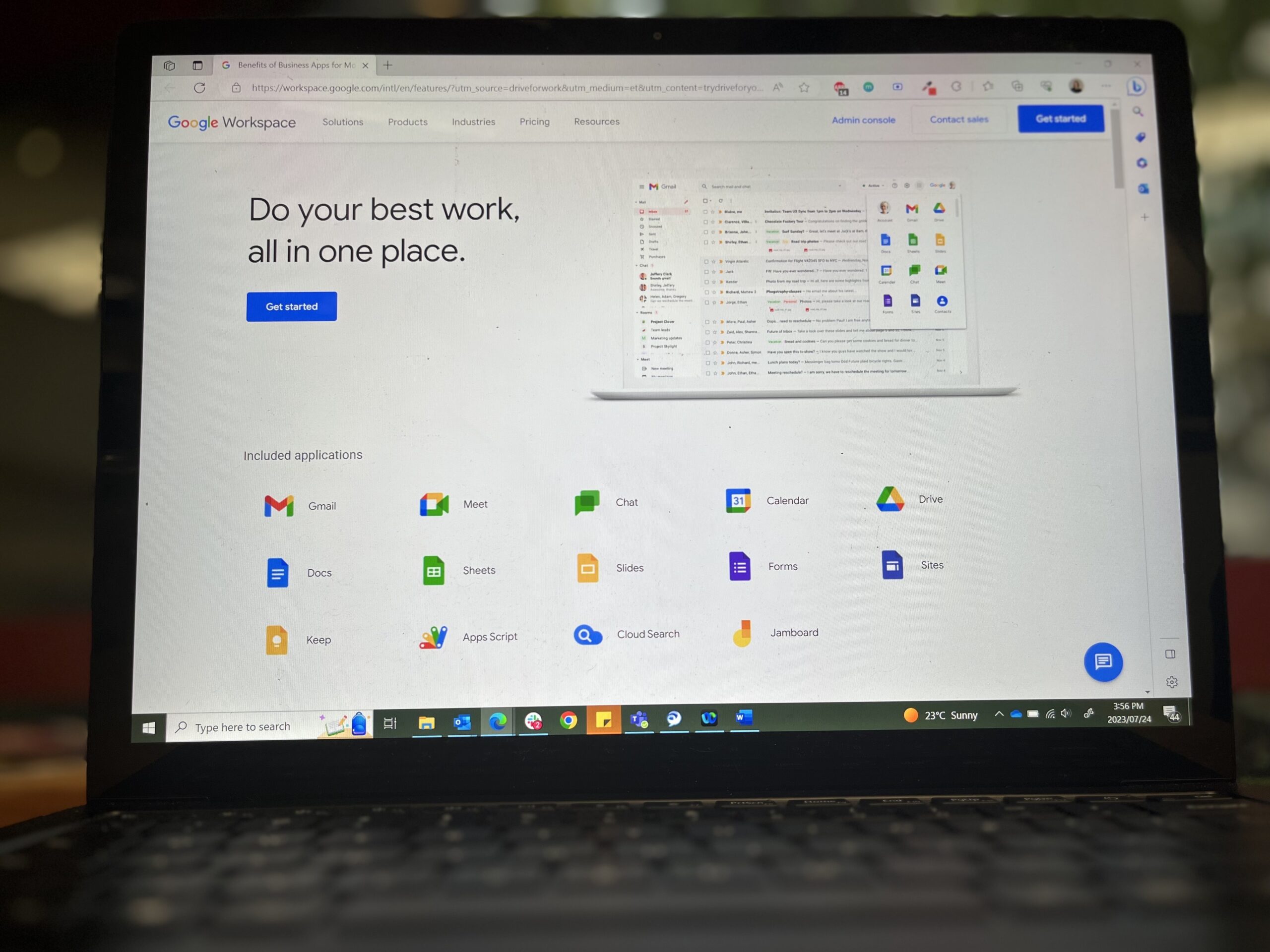 A black laptop shows the Google Workspace homepage--a white background with colourful Google Suite logos across the bottom of the page.