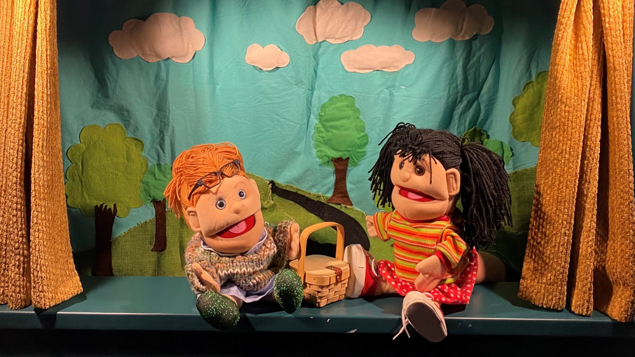 two puppets have a picnic
