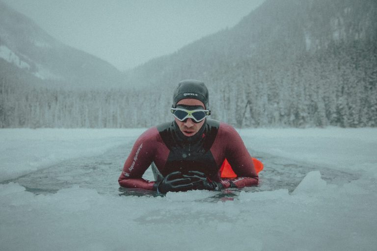 Man doing the swimming portion of a triathalon in Antarctica.