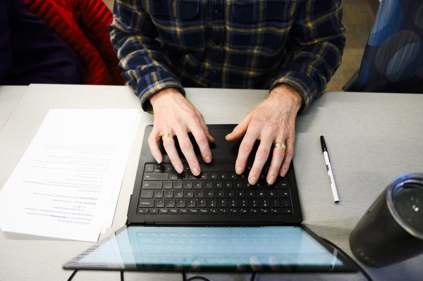 a bird's-eye view of someone's hands using a laptop