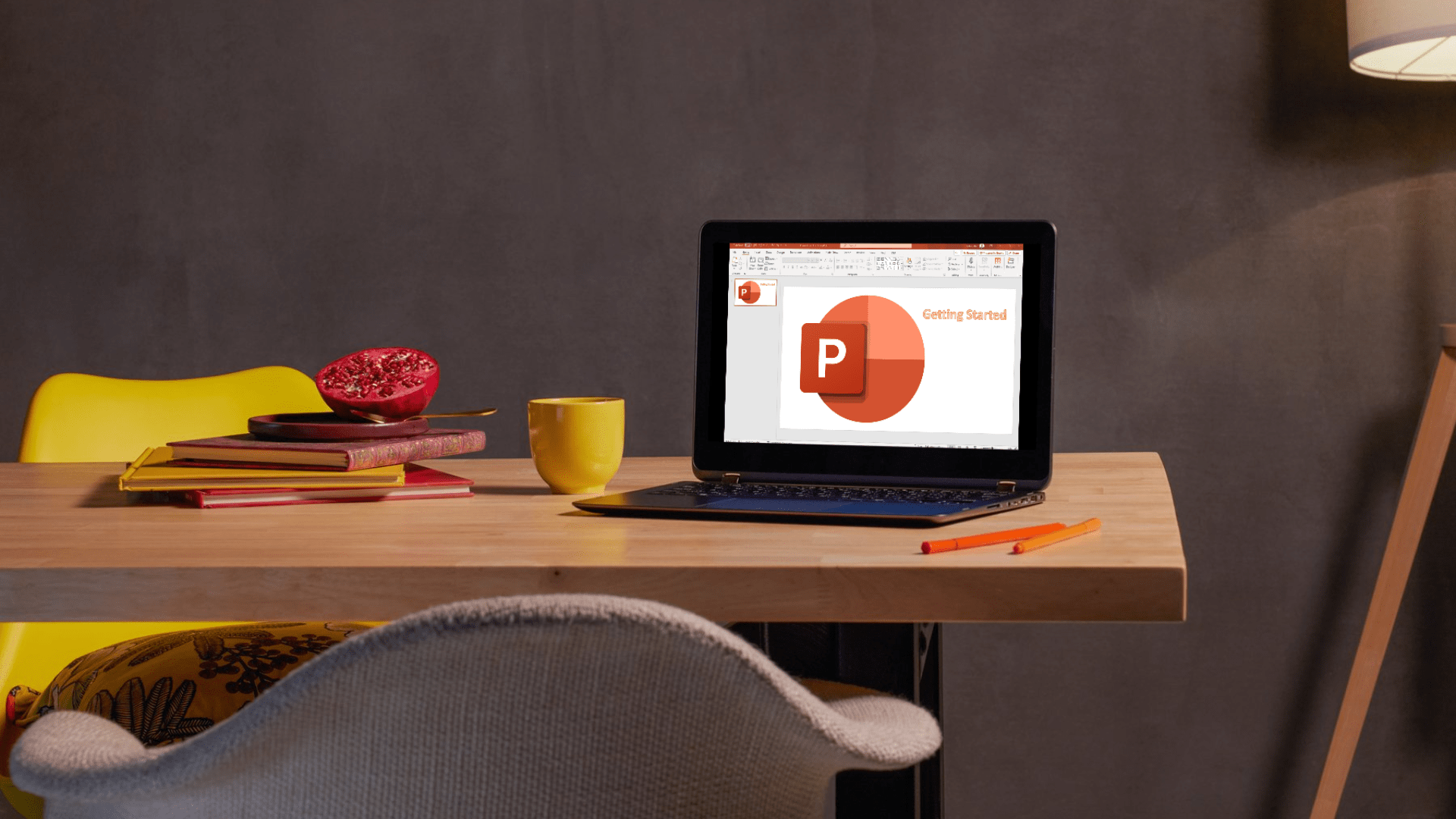 Laptop open to a PowerPoint presentation featuring the PowerPoint logo.