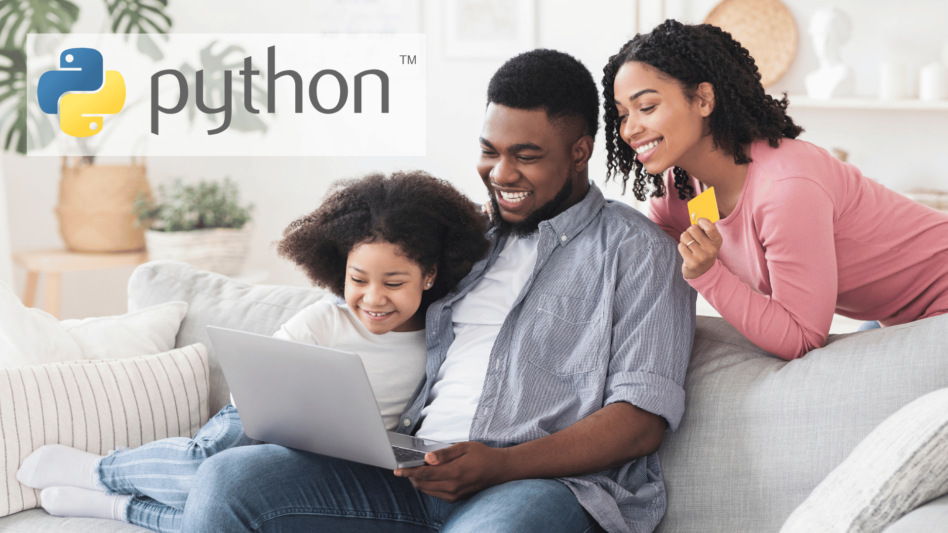 A child and two parents smile while using a laptop.