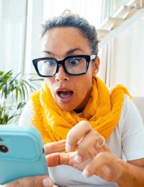 Astonished and surprised expression of woman using mobile phone. Virus or bad notification. Email and fraud website scam online. User lost password and security. Concept of clickbait and online fraud
