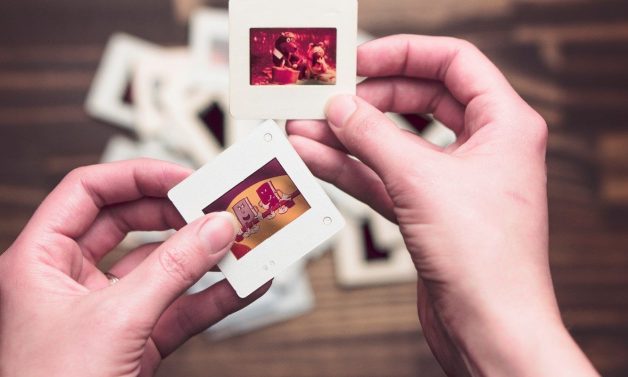 A person holds slides in their hands